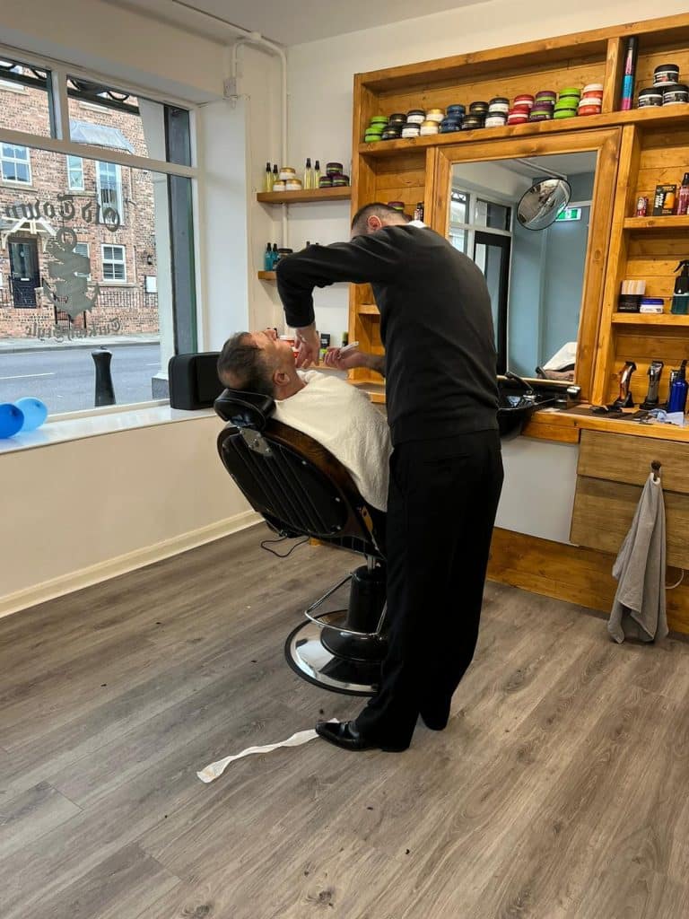 Barber cutting a customer’s hair at Old Town Barbers, Hartlepool