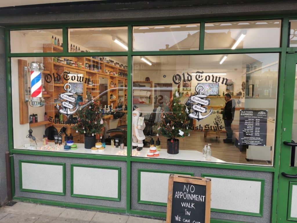 Barber pole and window display at Old Town Barbers, Hartlepool
