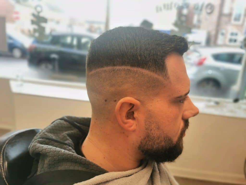 Side profile of a sharp fade haircut