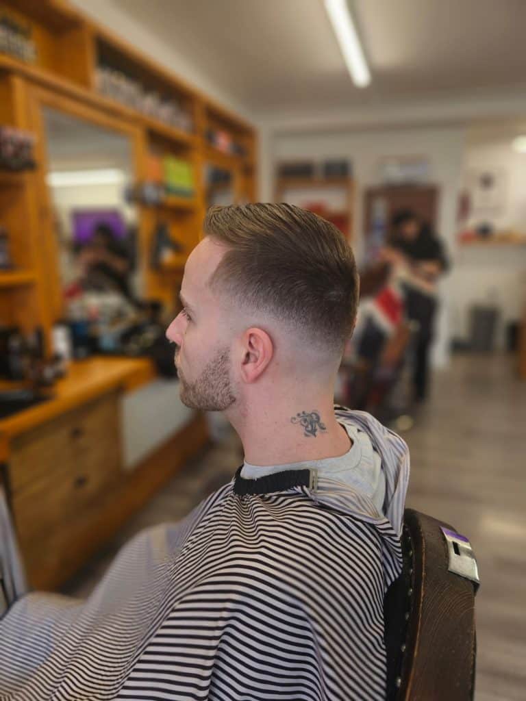Barber lining up a beard with clippers